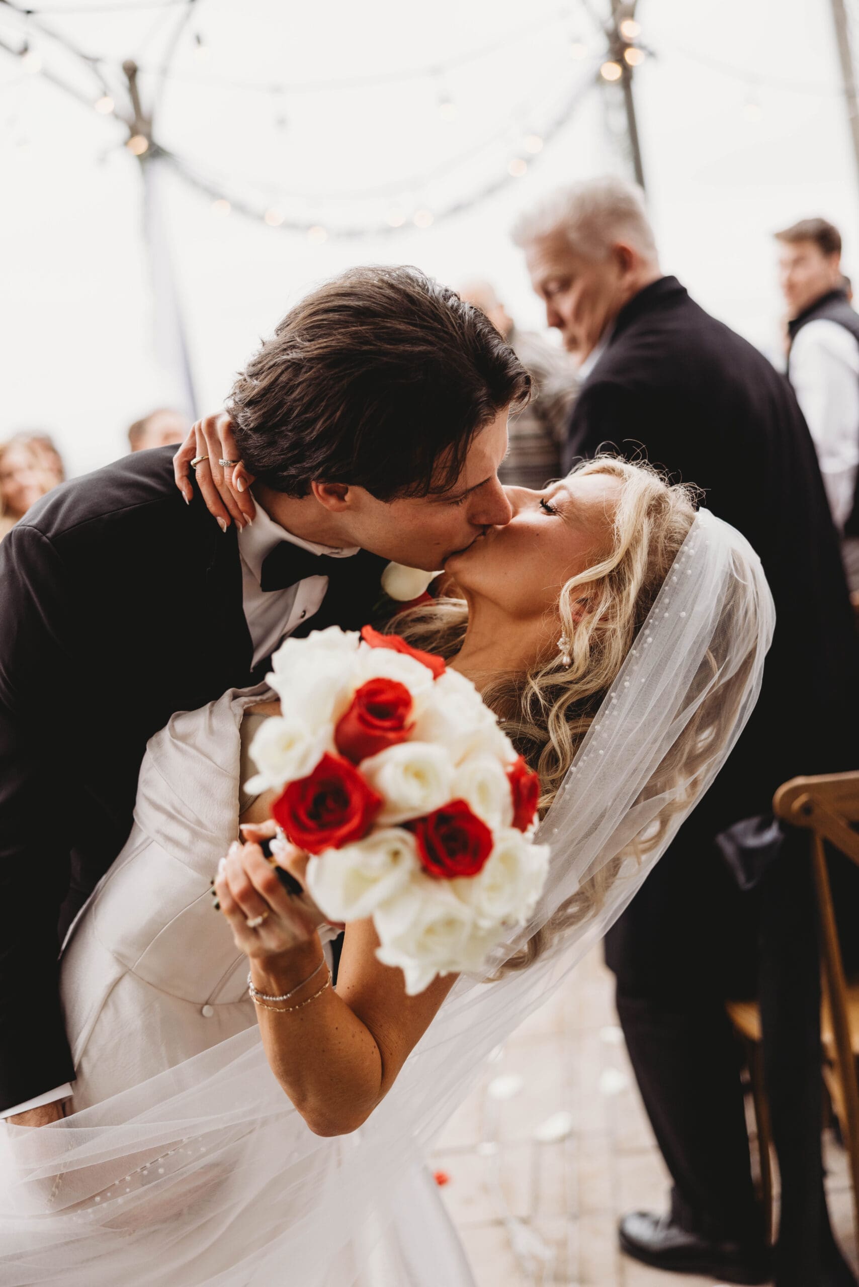 Bride being dipped by the groom after their wedding ceremony